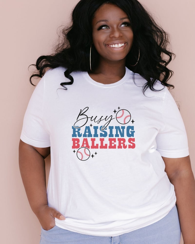 Front of a model wearing a size Large Busy Raising Ballers Colorful in White by Simply Sage Market. | dia_product_style_image_id:281369